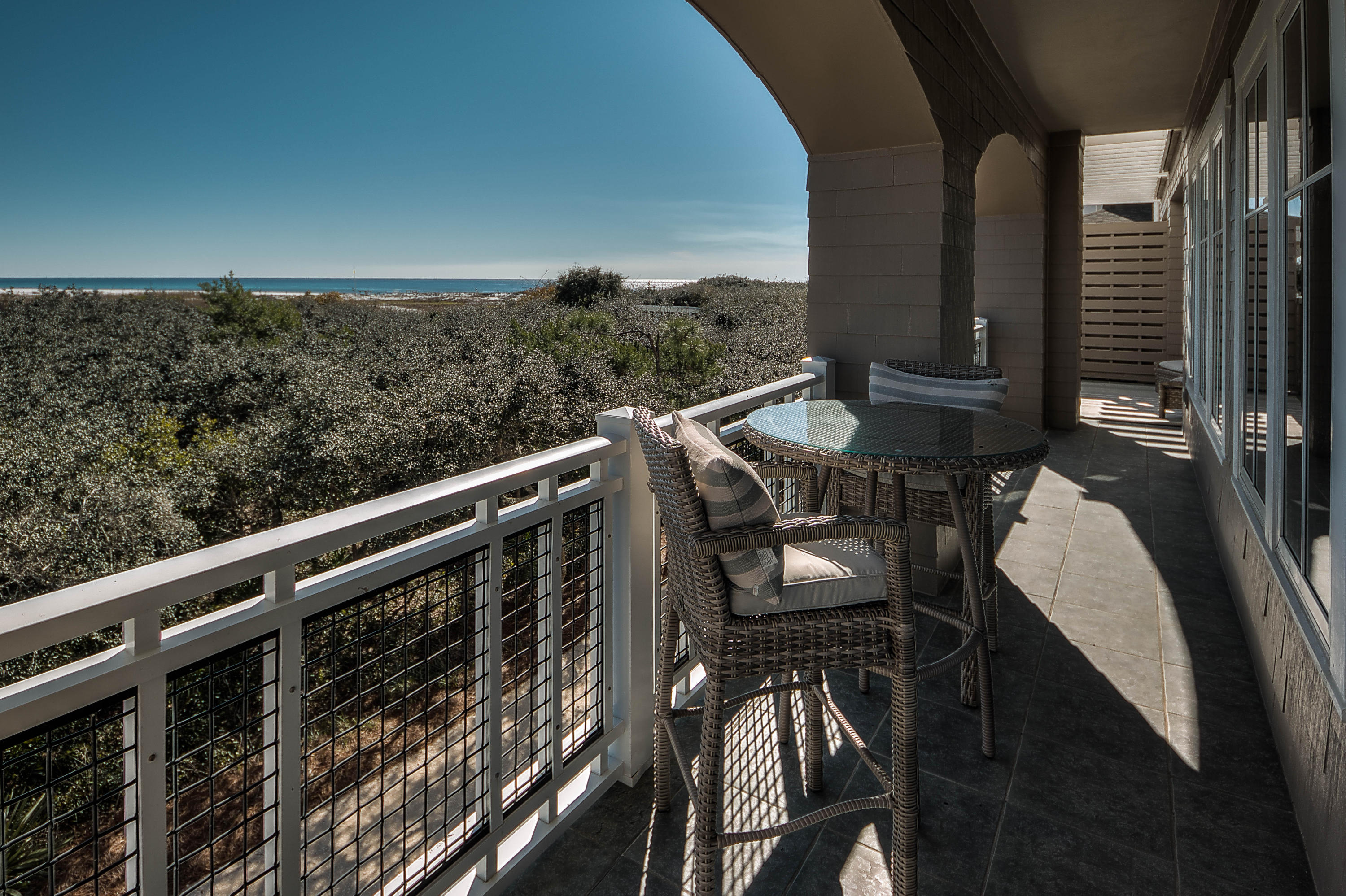 37 Compass Point Way, Unit 101 Watersound, FL 32461 - Photo 14 of 31 a view of a balcony with furniture and wooden floor