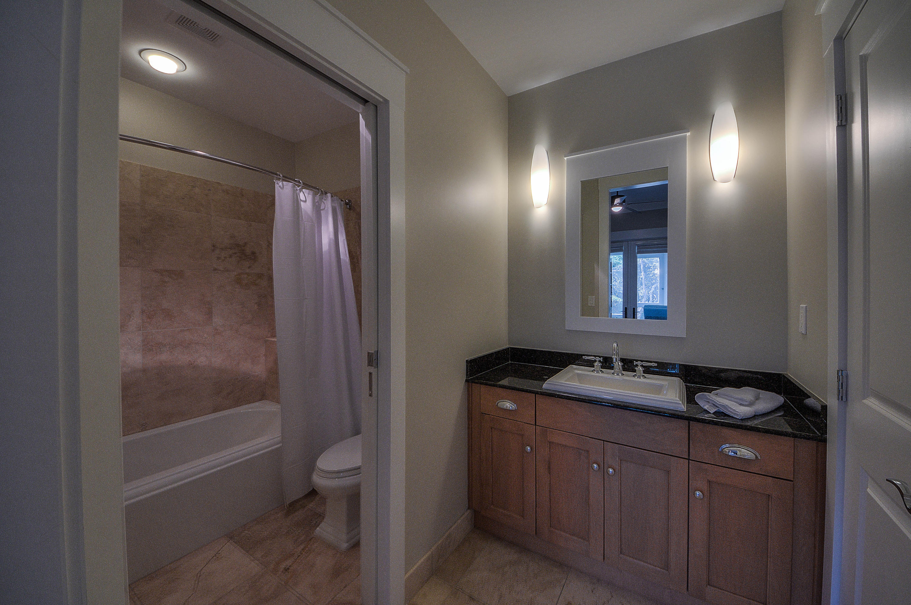 37 Compass Point Way, Unit 101 Watersound, FL 32461 - Photo 19 of 31 a bathroom with a granite countertop sink toilet and shower
