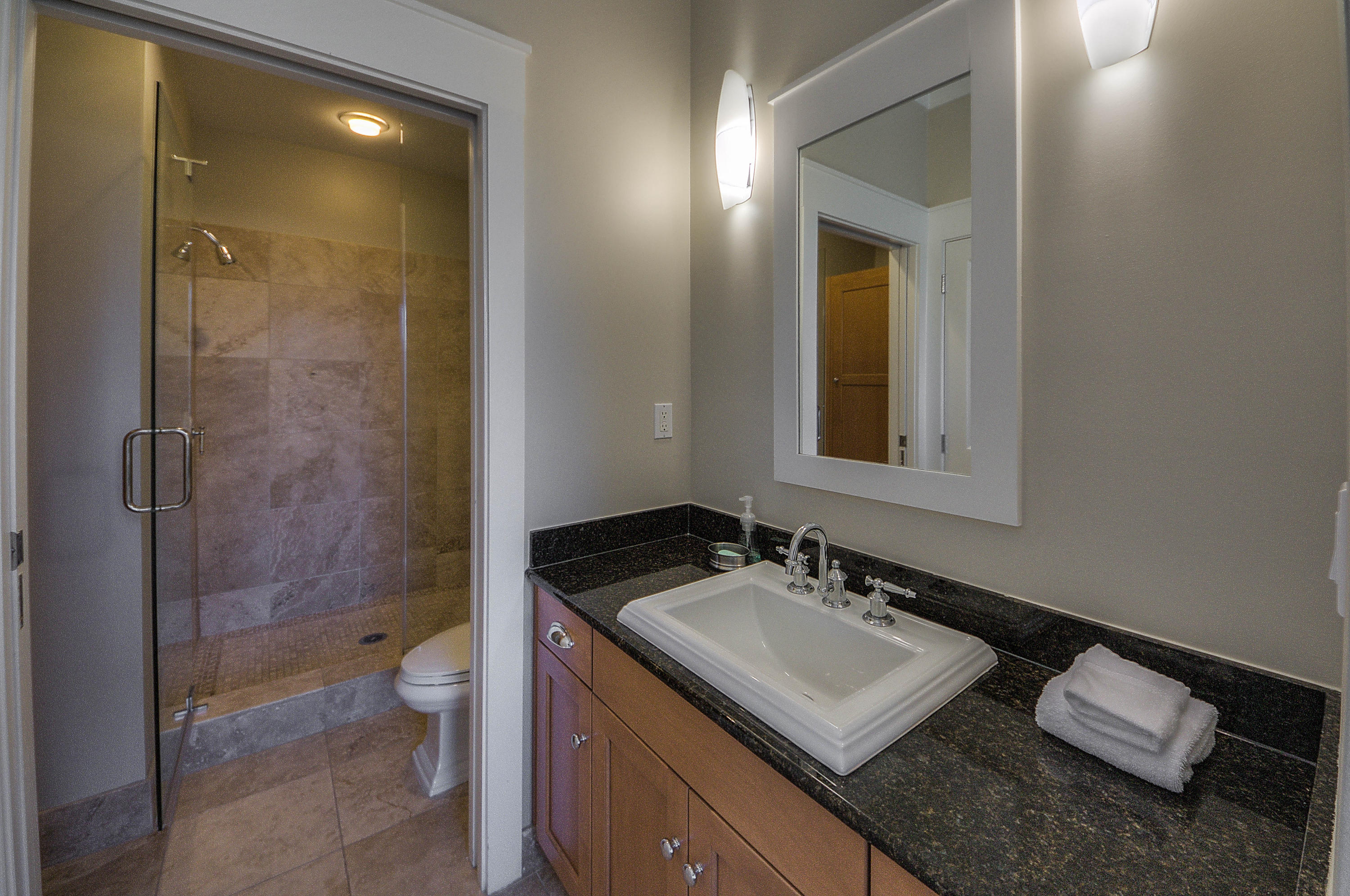 37 Compass Point Way, Unit 101 Watersound, FL 32461 - Photo 21 of 31 a bathroom with a sink toilet a mirror and shower