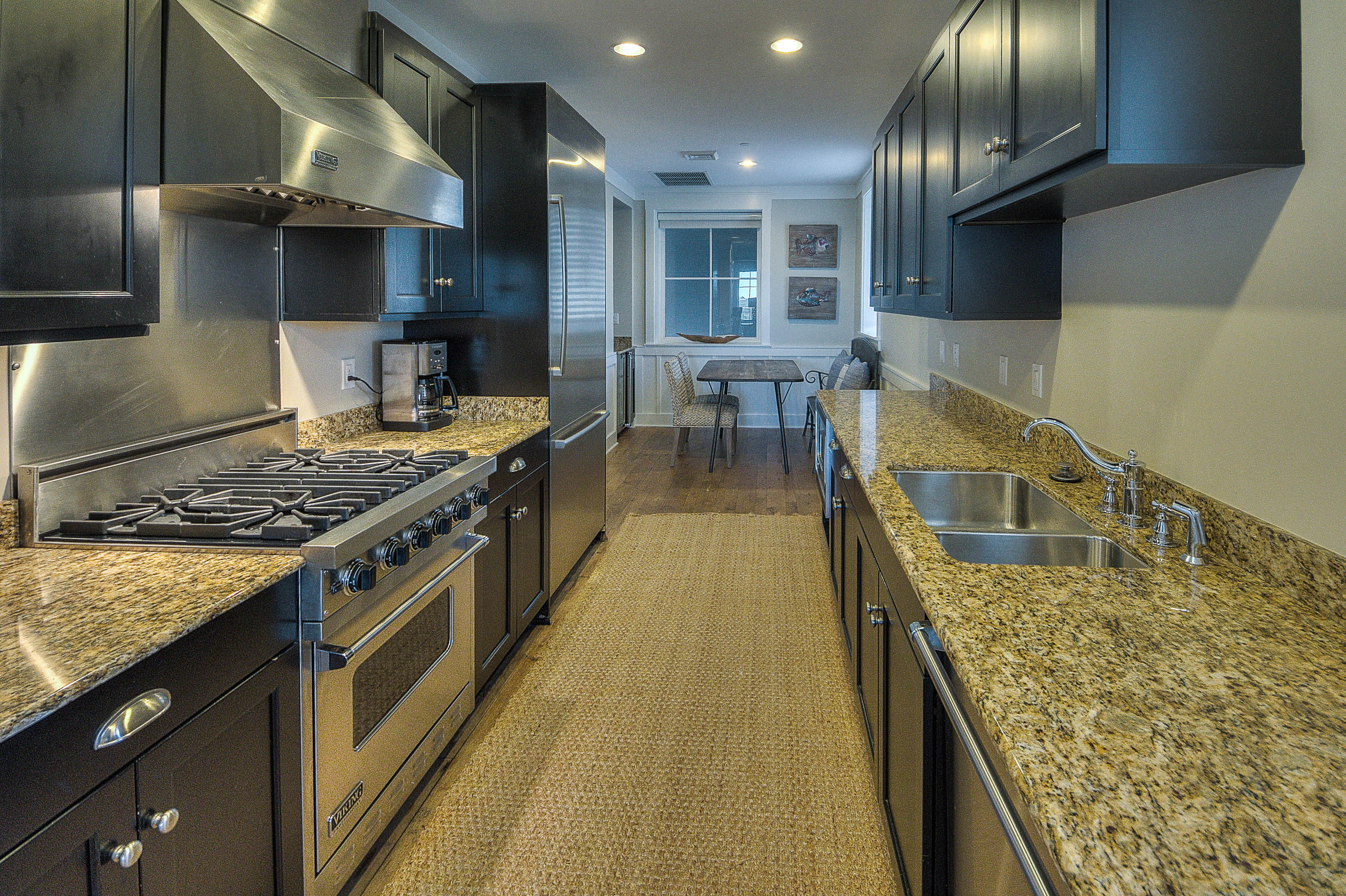 37 Compass Point Way, Unit 101 Watersound, FL 32461 - Photo 7 of 31 a kitchen with sink stove and cabinets
