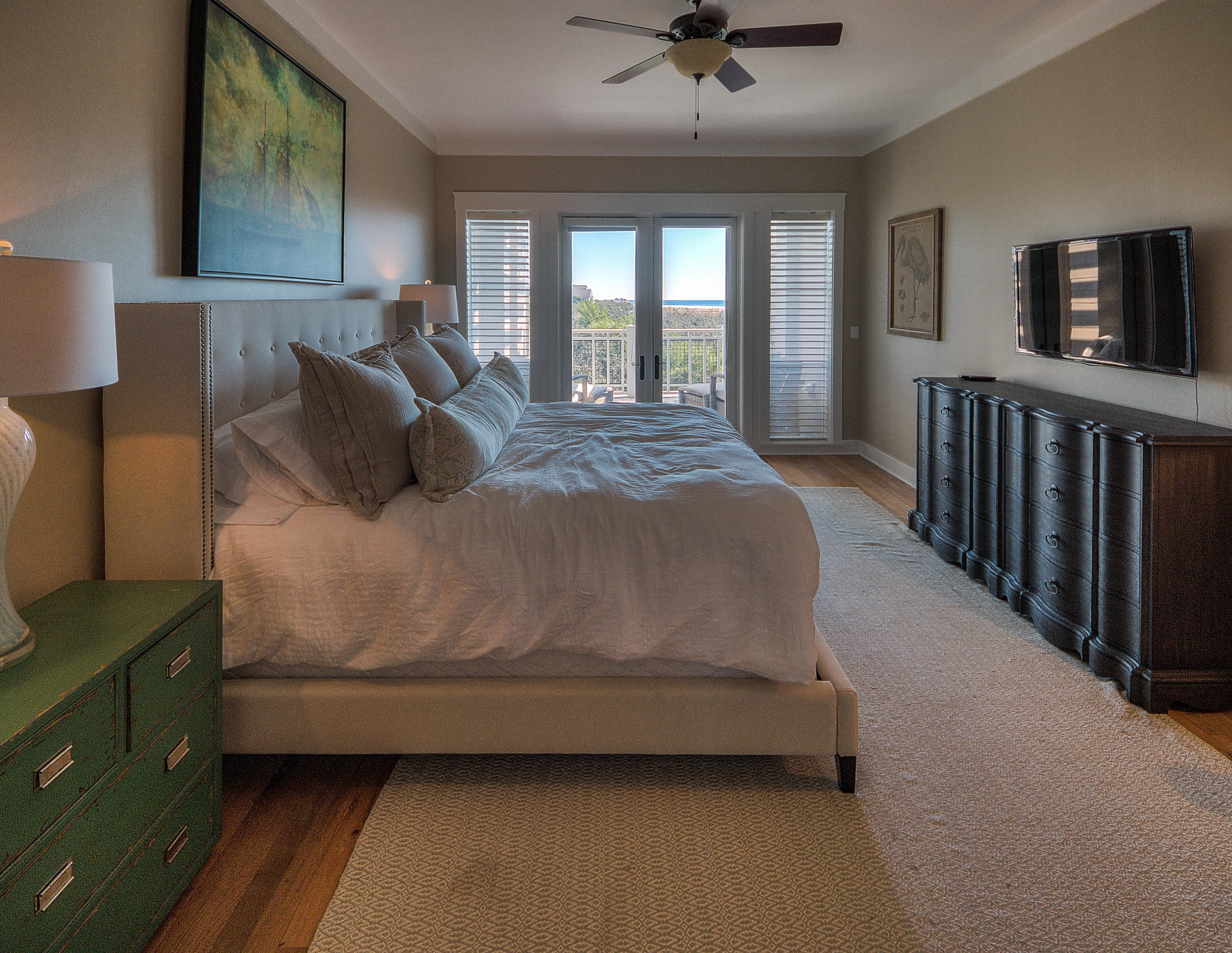 37 Compass Point Way, Unit 101 Watersound, FL 32461 - Photo 10 of 31 a large bed sitting in a bedroom next to a window