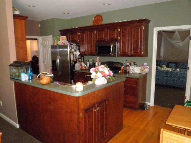 Kitchen area with custon cabinets and all new appliances, and the refrigerator STAYS!!!!