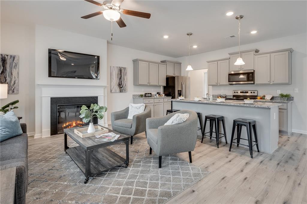 7441 Knoll Hollow Road Lithonia, GA 30058 - Photo 15 of 46 a living room with furniture a fireplace and a flat screen tv