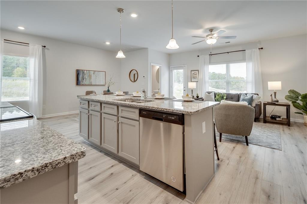 7441 Knoll Hollow Road Lithonia, GA 30058 - Photo 21 of 46 a kitchen with center island table and chairs