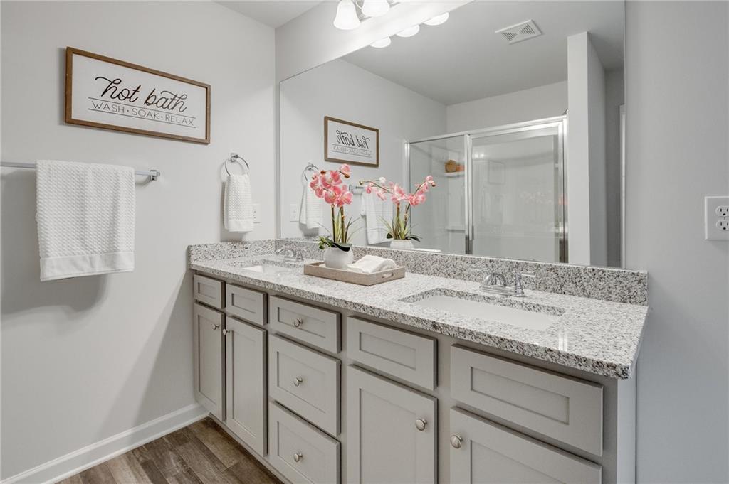 7441 Knoll Hollow Road Lithonia, GA 30058 - Photo 30 of 46 a bathroom with a sink and a mirror