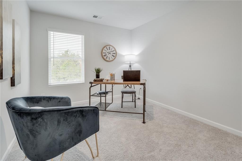 7441 Knoll Hollow Road Lithonia, GA 30058 - Photo 34 of 46 a living room with furniture and a window