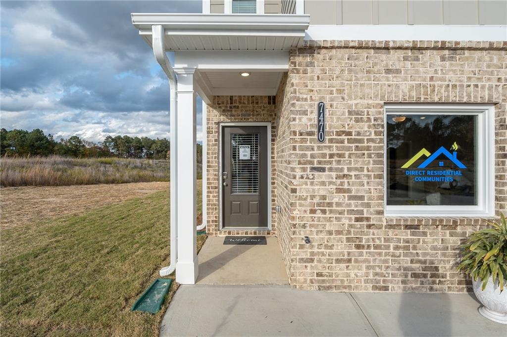 7441 Knoll Hollow Road Lithonia, GA 30058 - Photo 5 of 46 a brick house with a bench