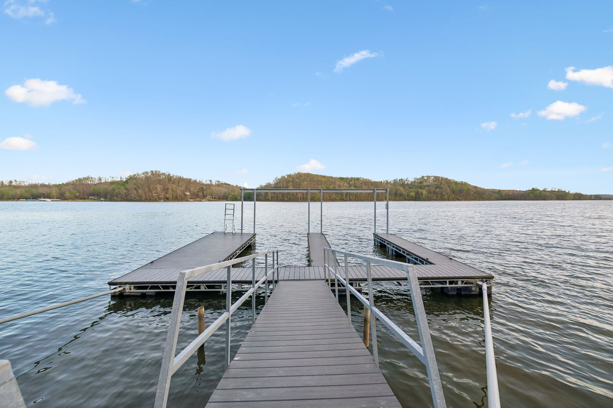 0 River Trace Road Dover, TN 37058 - Photo 2 of 19 a view of wooden deck and lake with mountain in the background