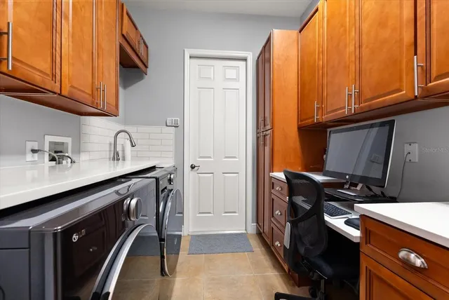 a kitchen with a sink a stove and cabinets