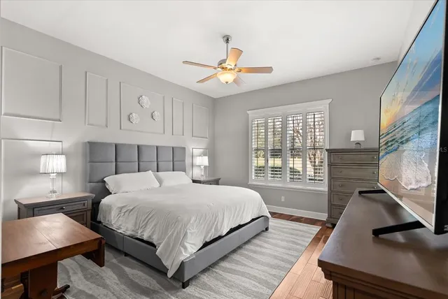 a bedroom with a large bed and a chandelier