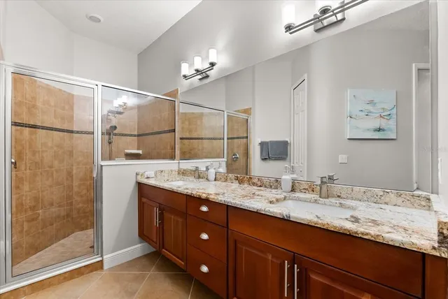 a bathroom with a granite countertop sink mirror and double