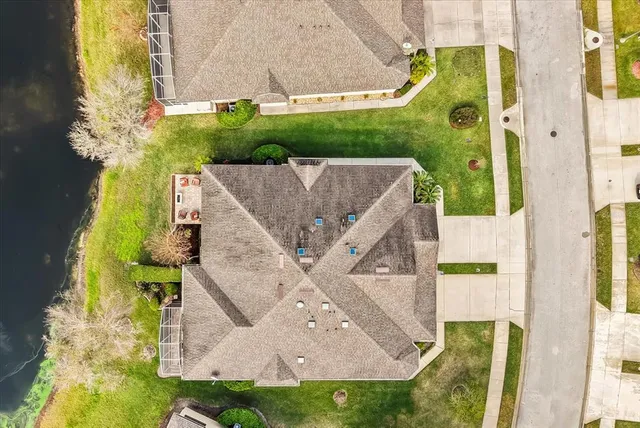 an aerial view of a house with a yard
