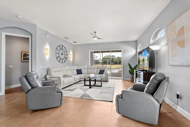 a living room with furniture and a large window