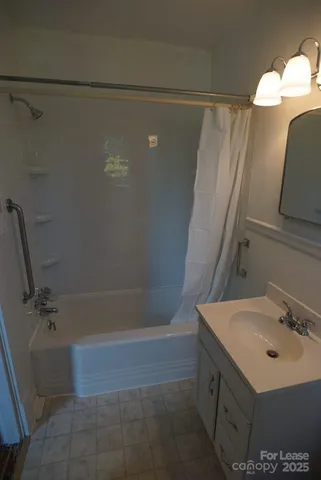 a bathroom with a sink a mirror and a shower