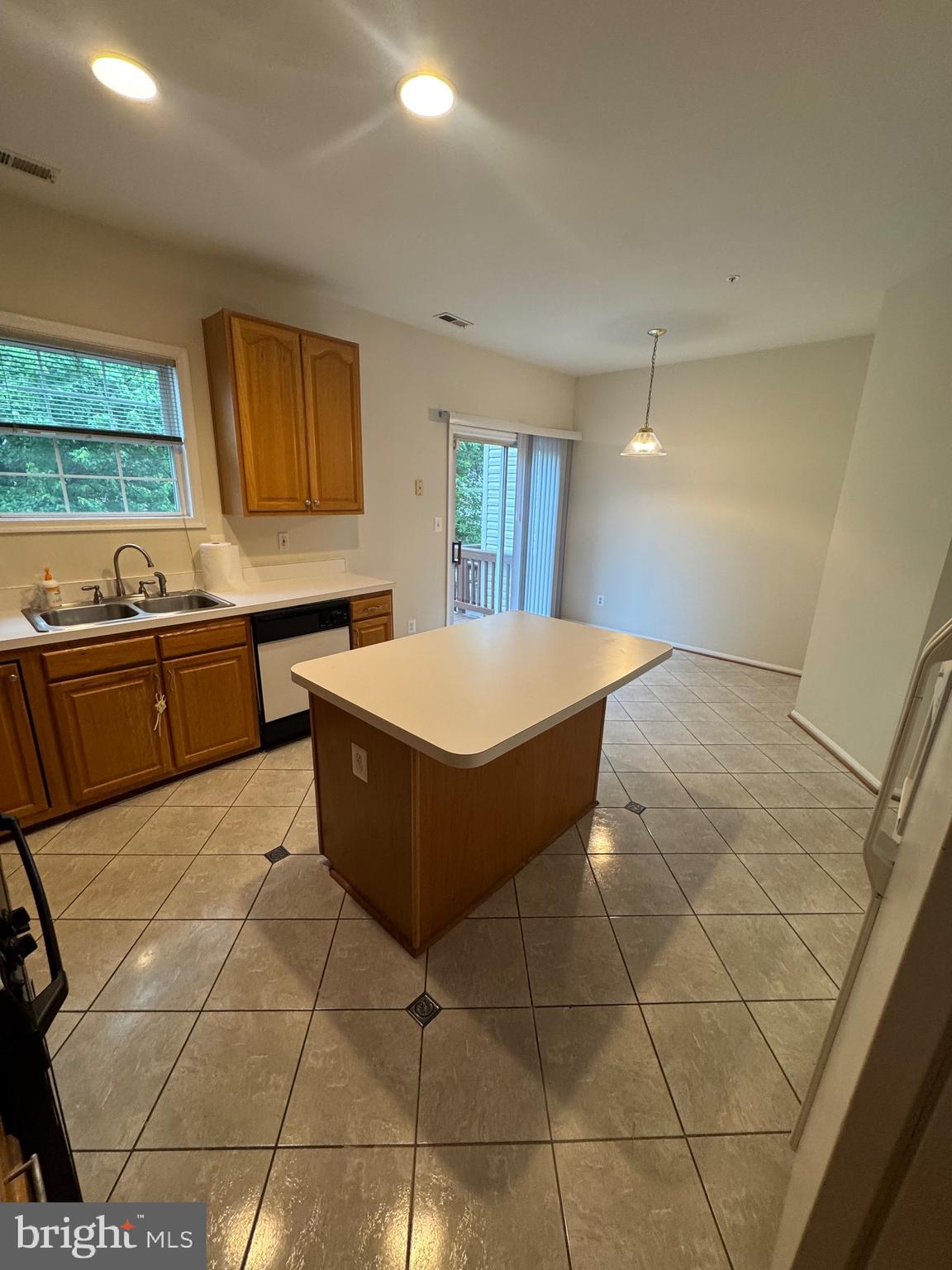 7705 Periwinkle Way, Unit 71 Severn, MD 21144 - Photo 14 of 28 a room with a wooden floor and white cabinets