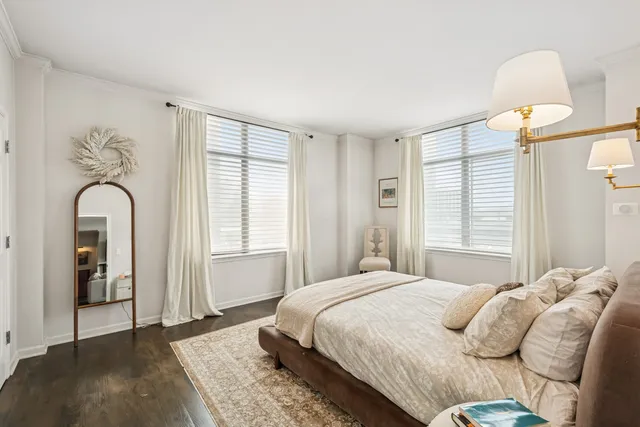 a bedroom with a large bed and a window