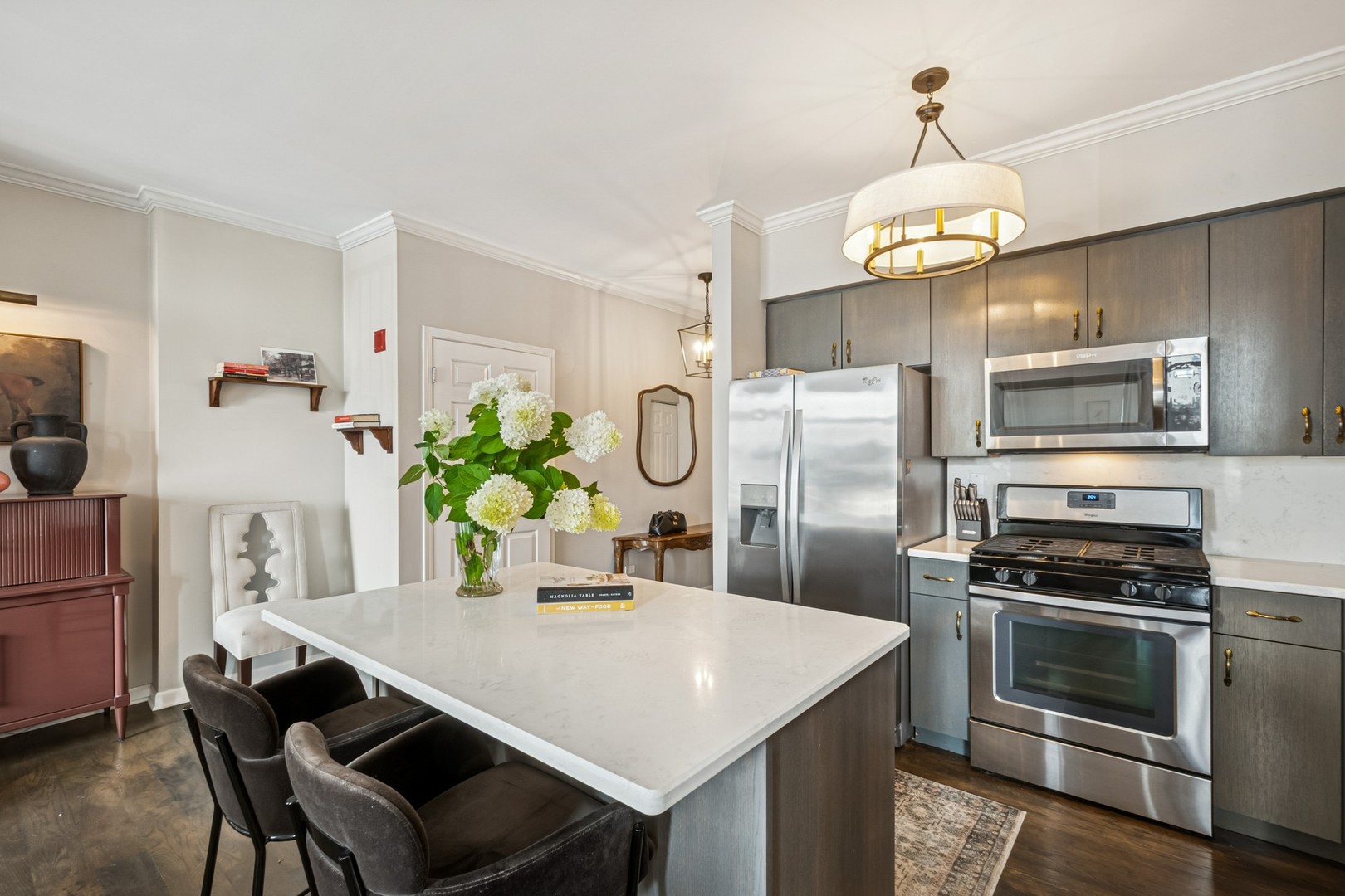 1122 North Dearborn Street, Unit 8E Chicago, IL 60610 - Photo 6 of 16 a kitchen with cabinets appliances and a dining table