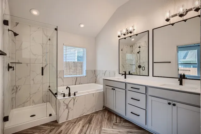 a bathroom with a double vanity sink mirror and shower