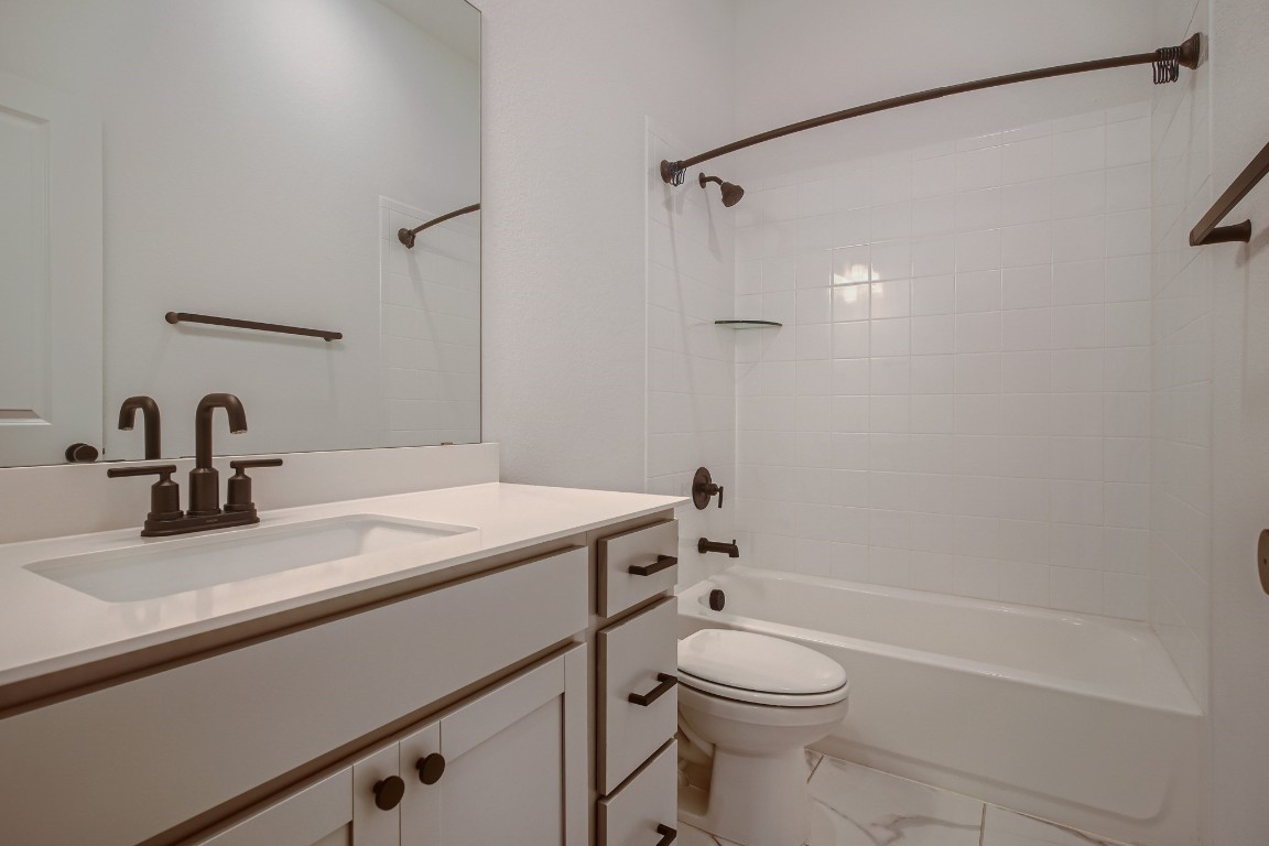 7904 Gilwice Lane Austin, TX 78744 - Photo 18 of 24 a bathroom with a sink a toilet and shower