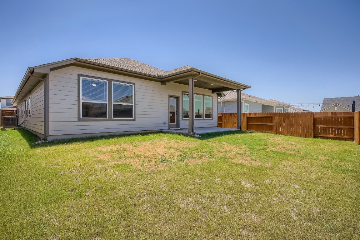 7904 Gilwice Lane Austin, TX 78744 - Photo 23 of 24 a front view of a house with a yard