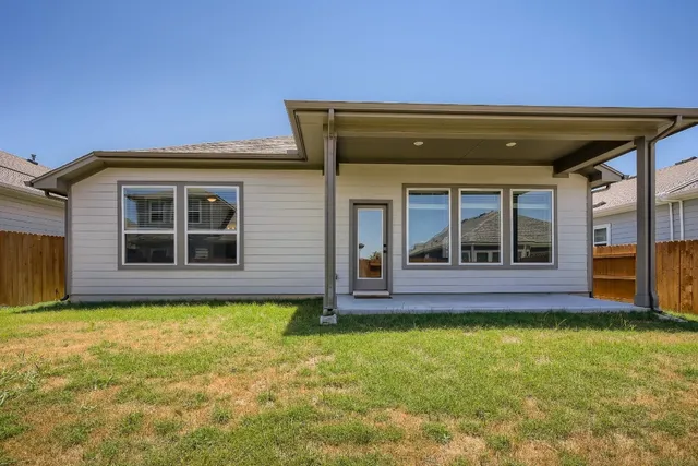 a view of a house with a backyard