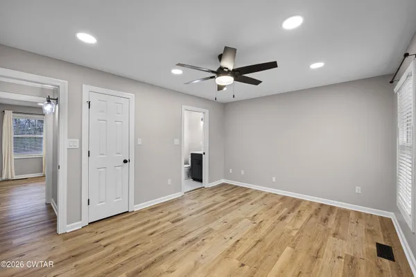 a view of an empty room with wooden floor