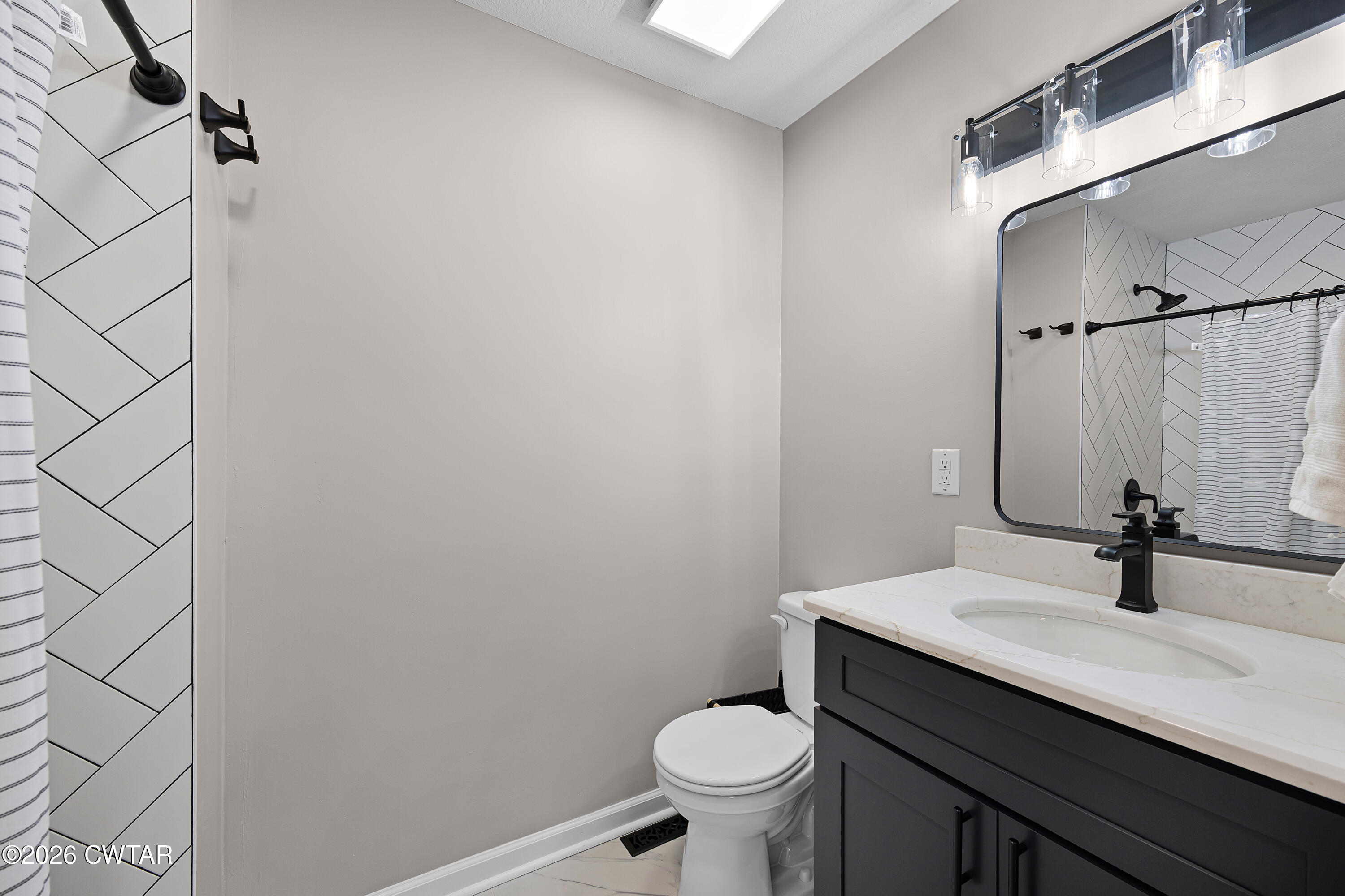 2436 Beech Bluff Road Jackson, TN 38301 - Photo 16 of 18 a bathroom with a sink toilet and mirror
