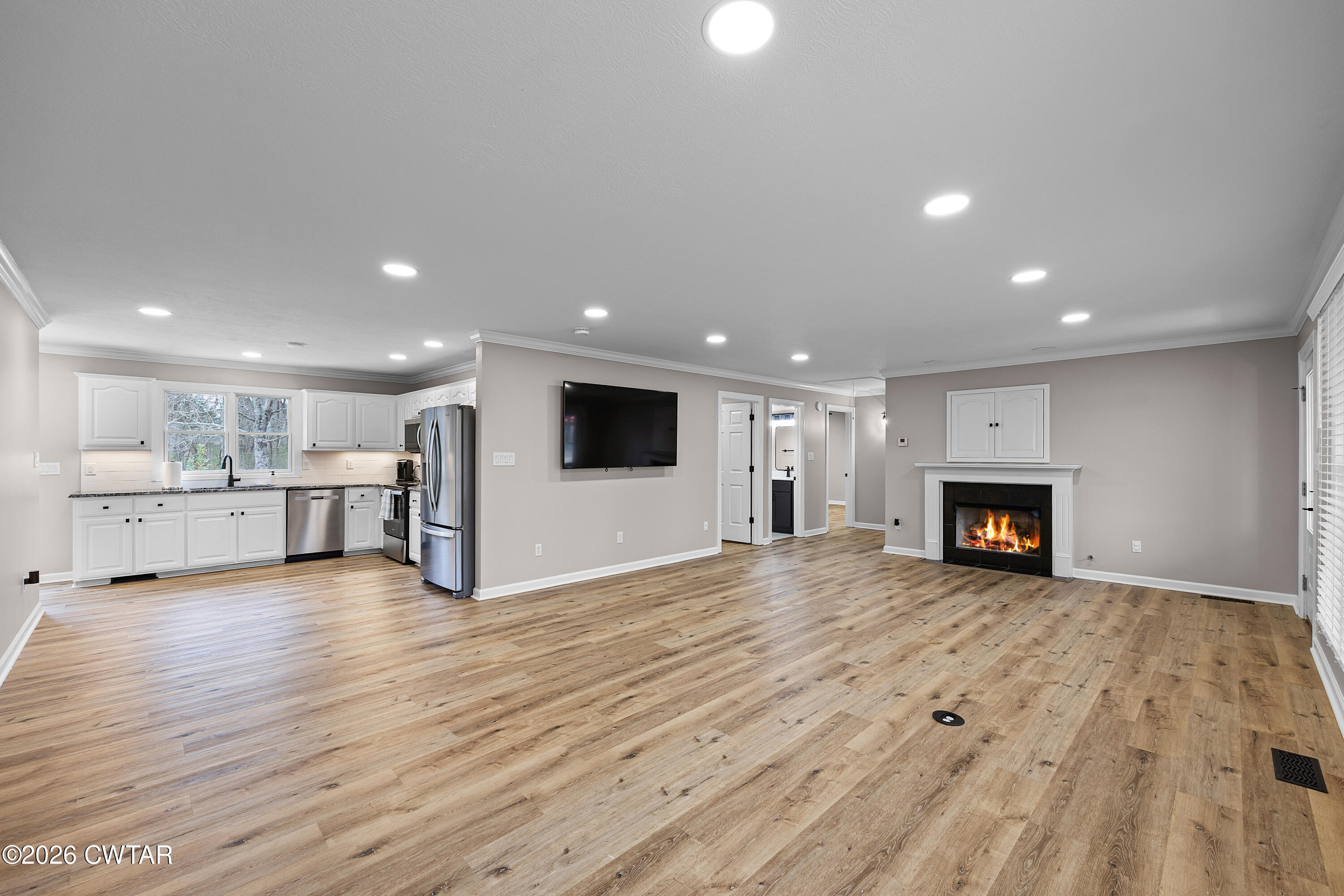 2436 Beech Bluff Road Jackson, TN 38301 - Photo 10 of 18 a view of a big room with wooden floor and a kitchen