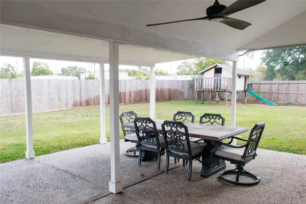 a view of an outdoor dining space with furniture and garden