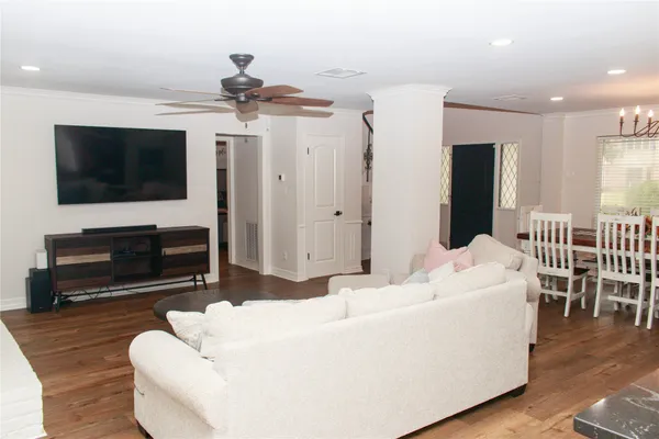 a kitchen with stainless steel appliances a stove a refrigerator and wooden floor