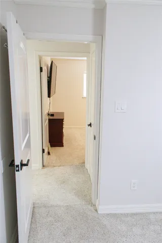 a bedroom with a bed and a television