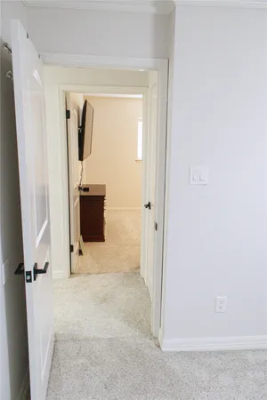 a bedroom with a bed and a television