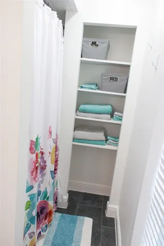 a spacious bedroom with a bed and a window