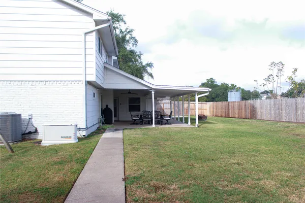 a view of a house with backyard and porch