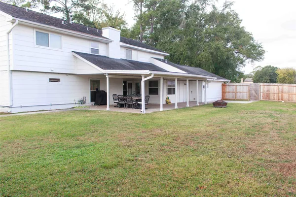 a view of a house with a yard and sitting area