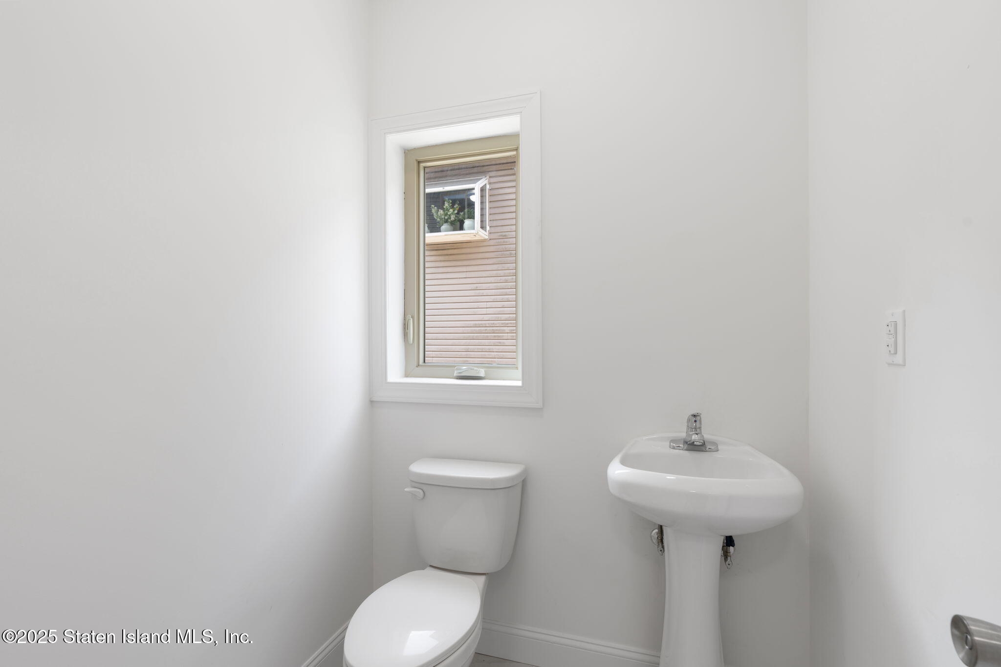 1370 Forest Hill Road, Unit 2B Staten Island, NY 10314 - Photo 12 of 20 a bathroom with a sink toilet and mirror