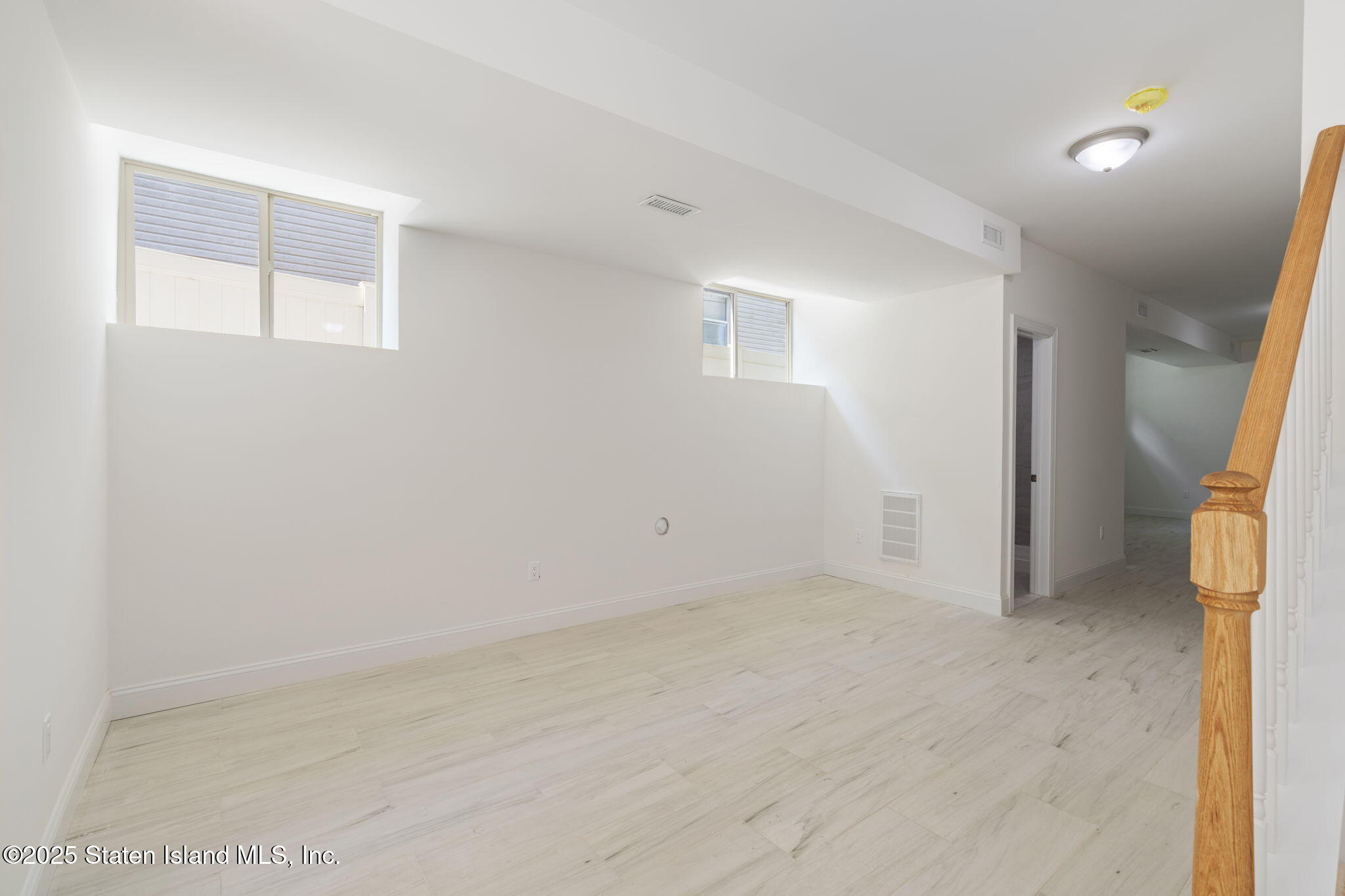 1370 Forest Hill Road, Unit 2B Staten Island, NY 10314 - Photo 13 of 20 an empty room with windows