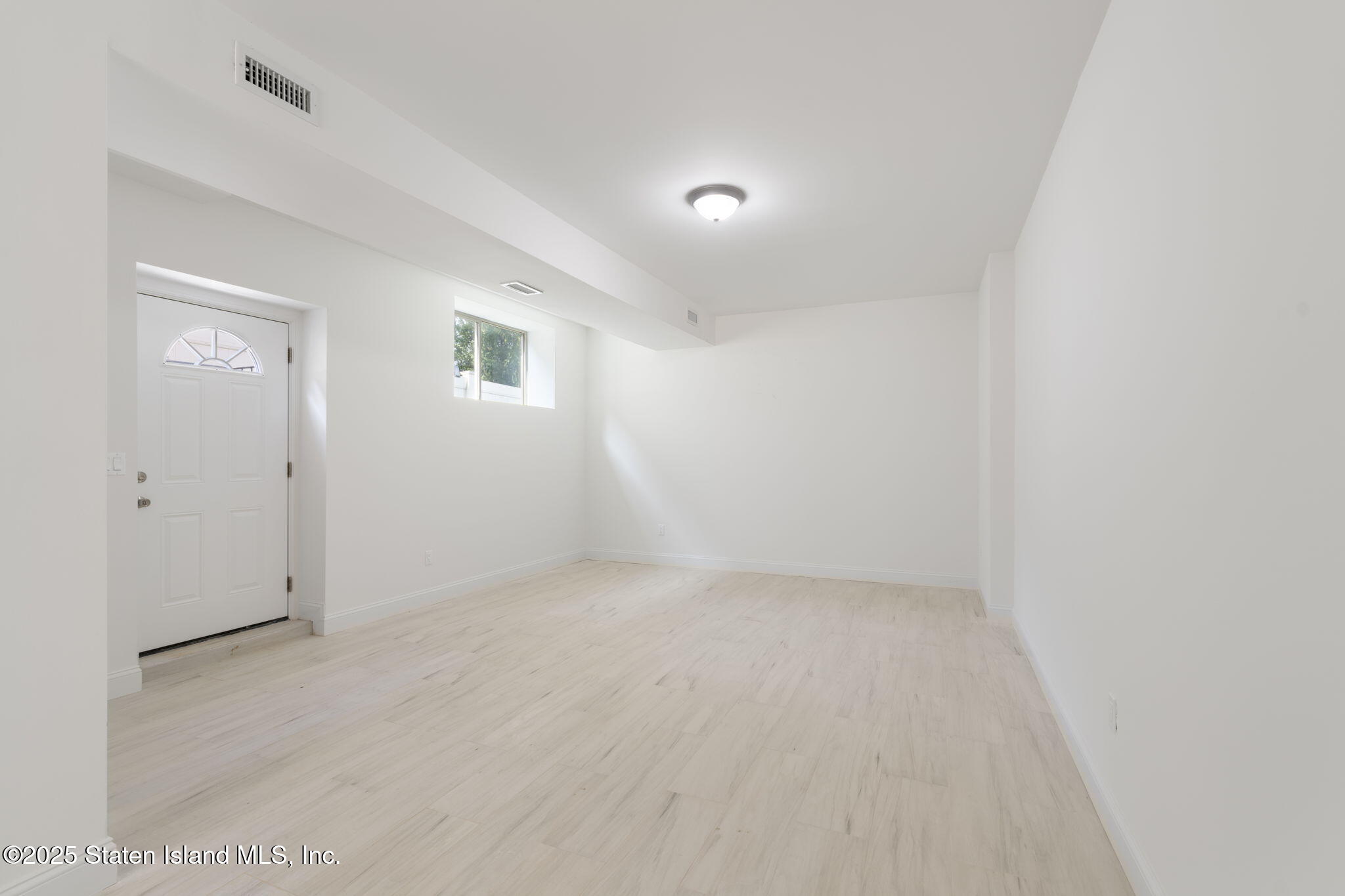 1370 Forest Hill Road, Unit 2B Staten Island, NY 10314 - Photo 14 of 20 an empty room with a natural light