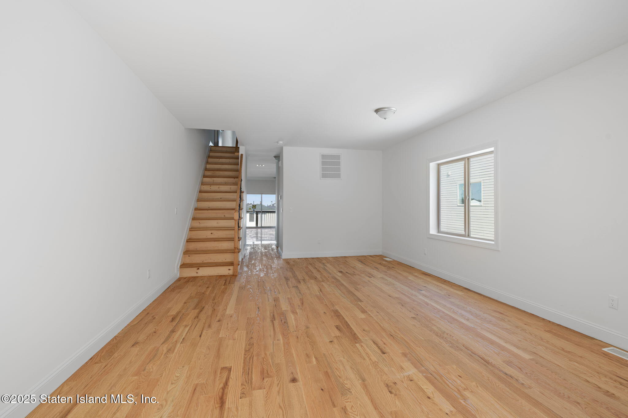 1370 Forest Hill Road, Unit 2B Staten Island, NY 10314 - Photo 3 of 20 a view of wooden floor and windows in a room
