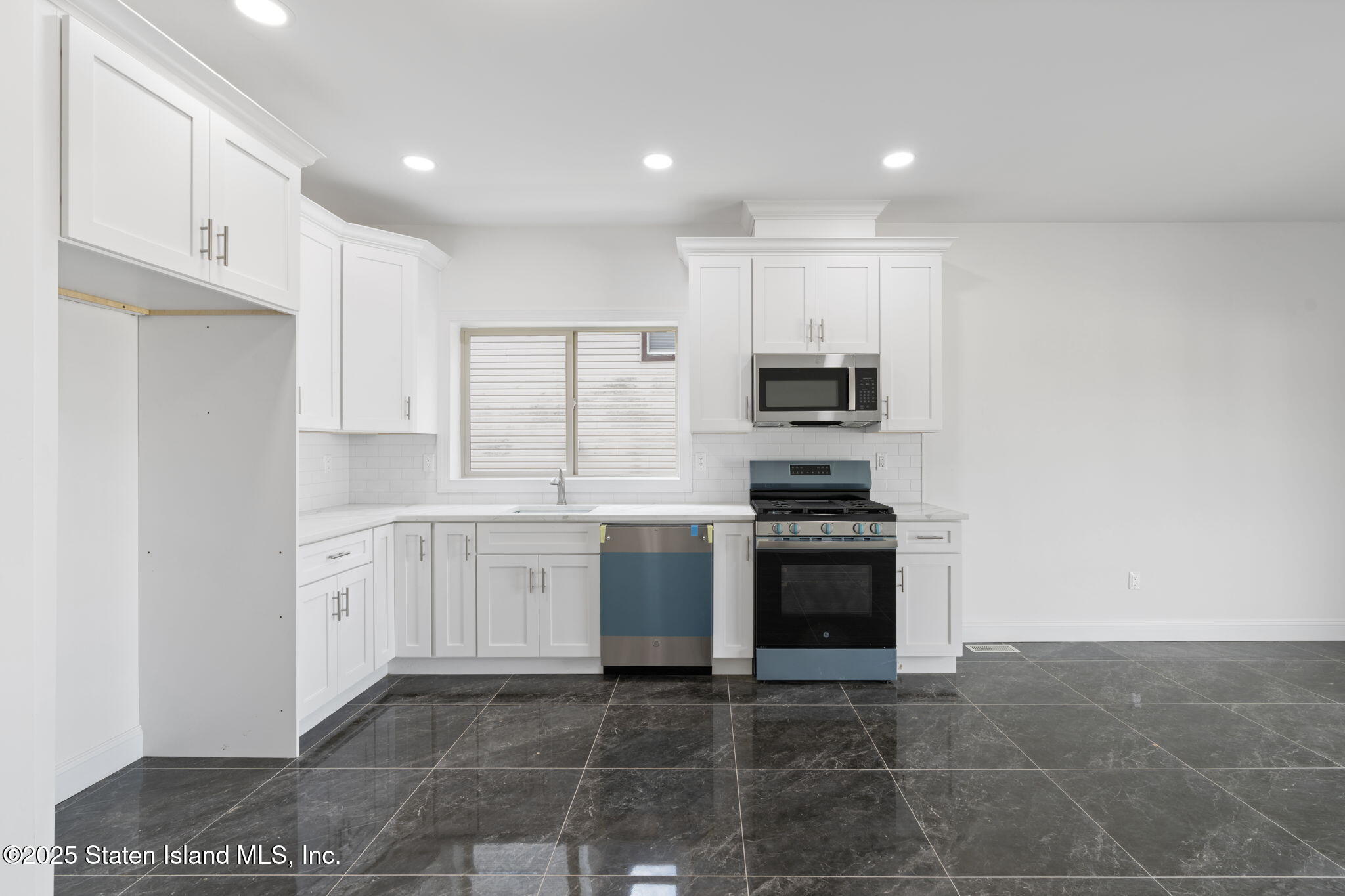 1370 Forest Hill Road, Unit 2B Staten Island, NY 10314 - Photo 4 of 20 a large kitchen with a stove top oven a sink and dishwasher