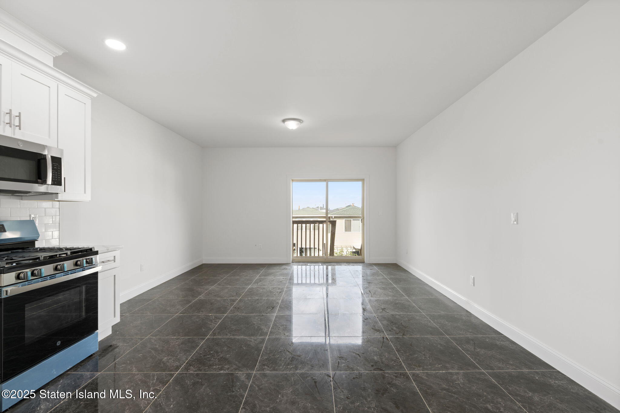 1370 Forest Hill Road, Unit 2B Staten Island, NY 10314 - Photo 5 of 20 a view of an empty room with a kitchen