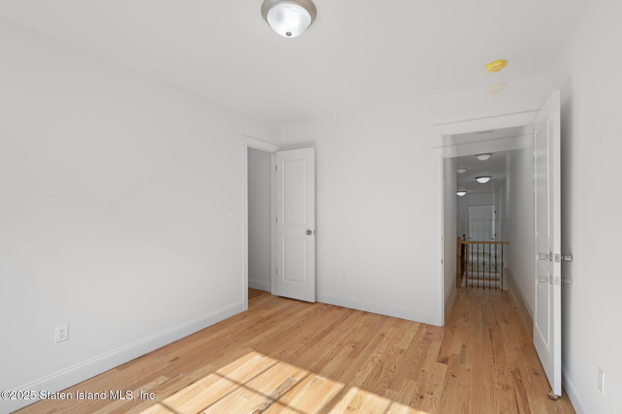 1370 Forest Hill Road, Unit 2B Staten Island, NY 10314 - Photo 8 of 20 a view of a room with wooden floor and bathroom