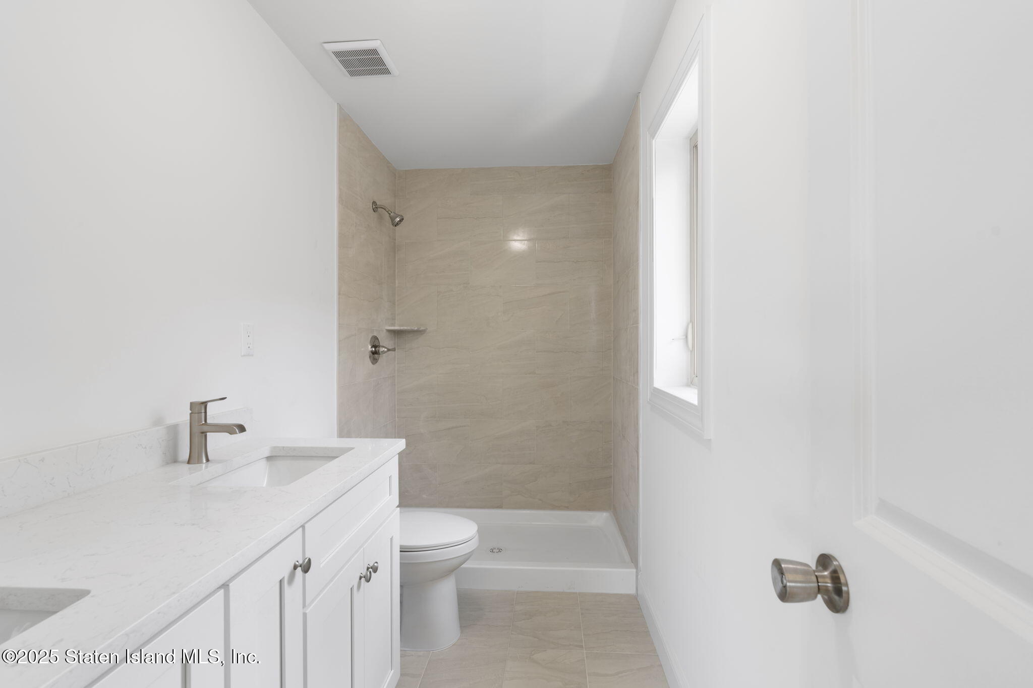 1370 Forest Hill Road, Unit 2B Staten Island, NY 10314 - Photo 10 of 20 a bathroom with a sink a toilet and shower
