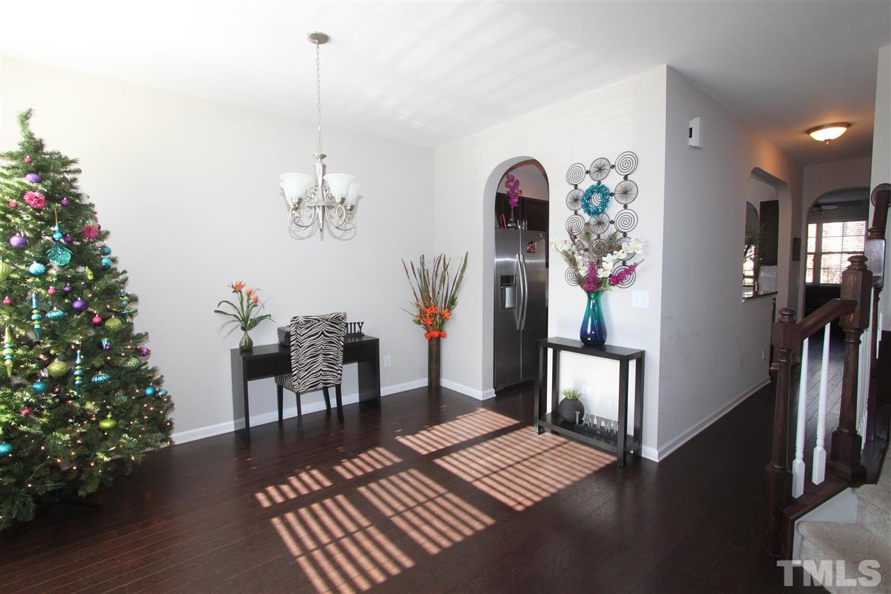 760 Wickham Ridge Road Apex, NC 27539 - Photo 2 of 25 a living room with furniture and a potted plant