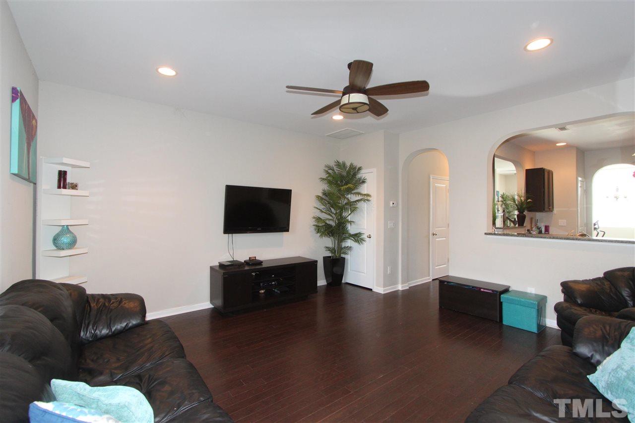 760 Wickham Ridge Road Apex, NC 27539 - Photo 11 of 25 a living room with furniture and a flat screen tv