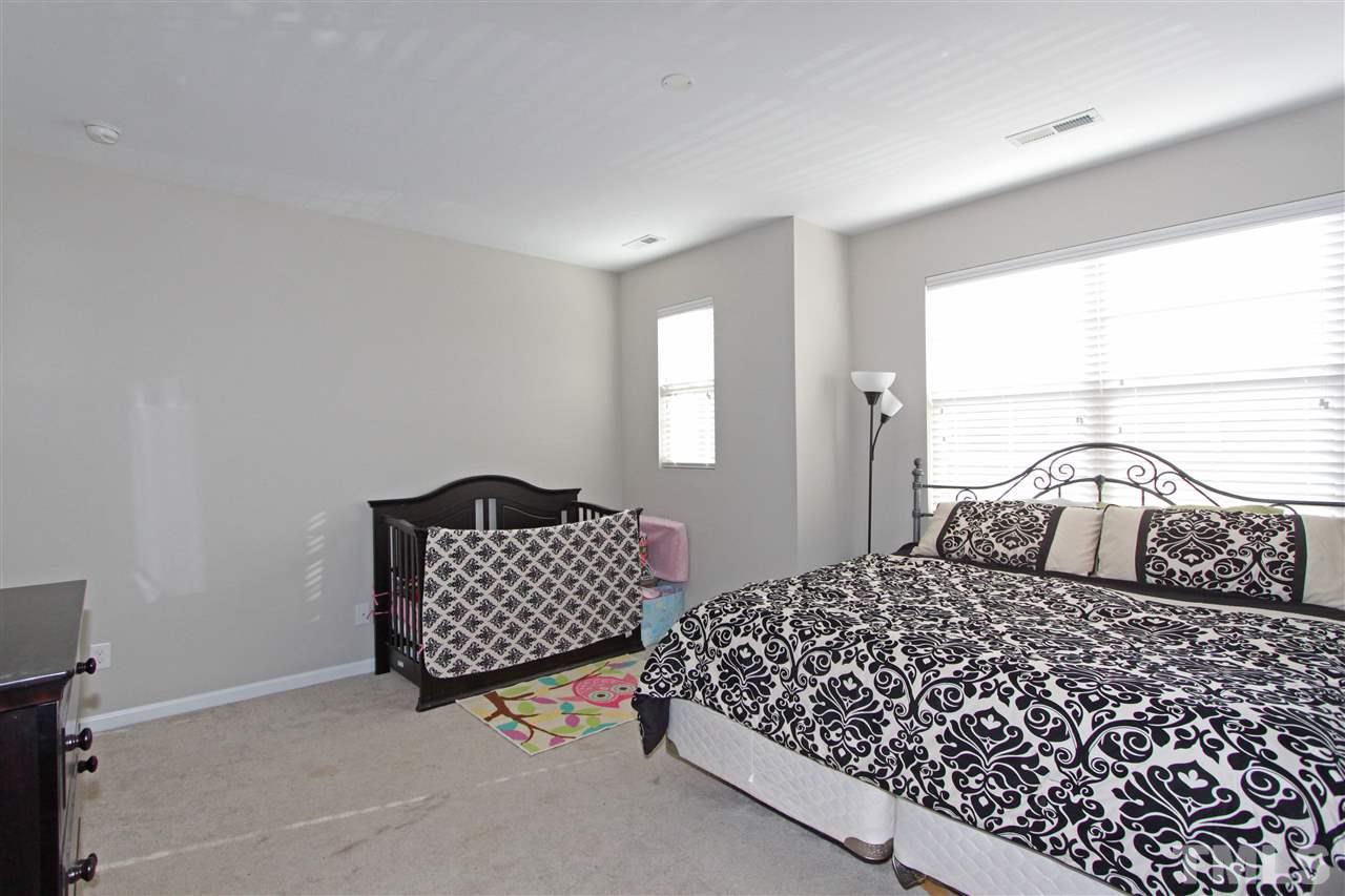 760 Wickham Ridge Road Apex, NC 27539 - Photo 14 of 25 a bedroom with a bed and window