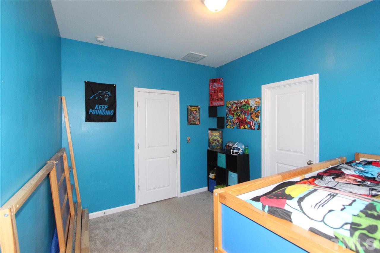 760 Wickham Ridge Road Apex, NC 27539 - Photo 20 of 25 a bedroom with a bed and a dresser