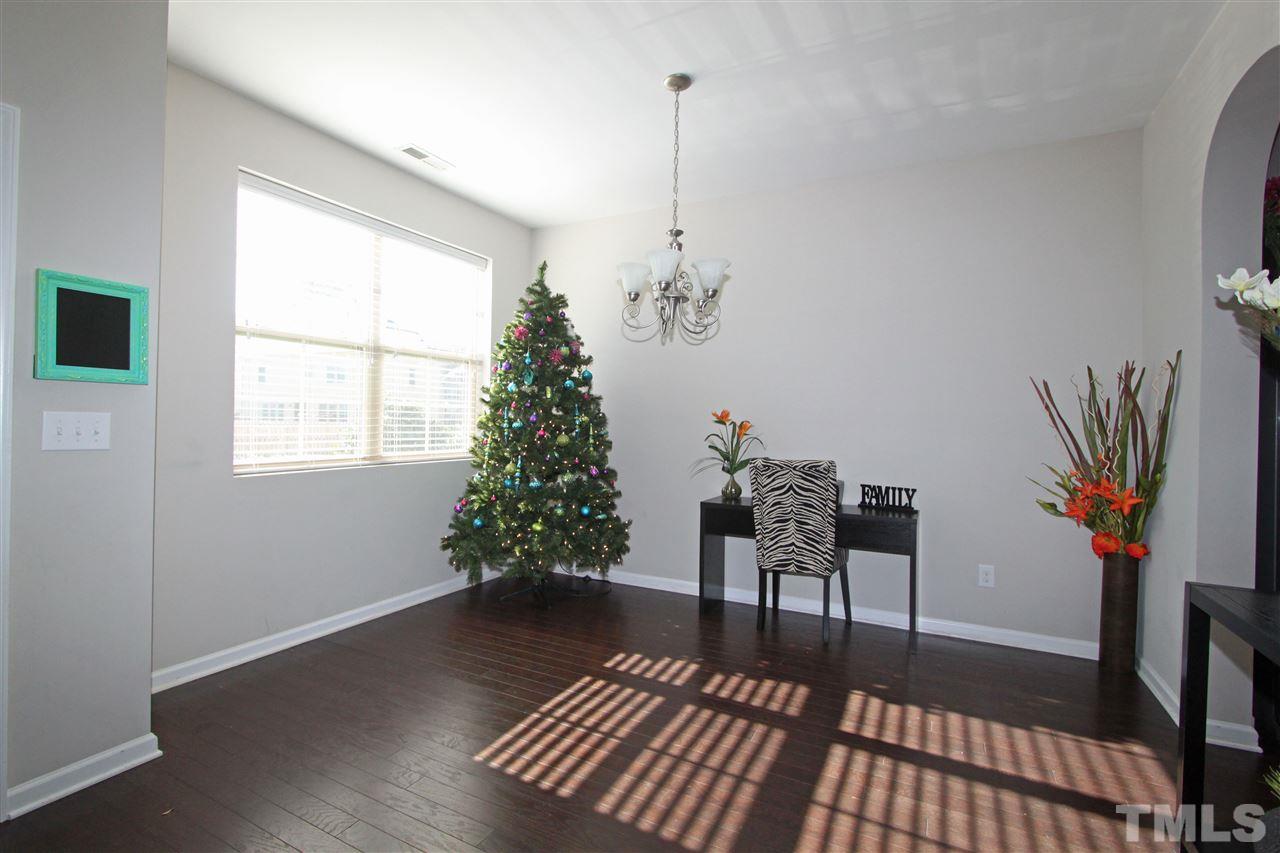 760 Wickham Ridge Road Apex, NC 27539 - Photo 3 of 25 a living room with furniture and a potted plant