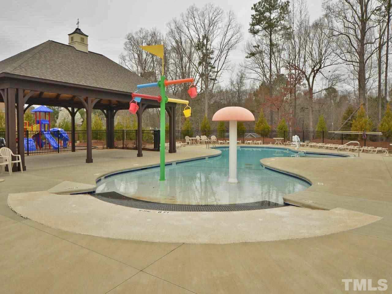 760 Wickham Ridge Road Apex, NC 27539 - Photo 24 of 25 swimming pool view with a garden and seating area
