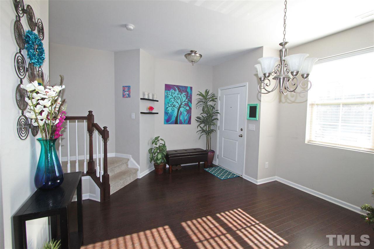 760 Wickham Ridge Road Apex, NC 27539 - Photo 4 of 25 a living room with furniture and a chandelier